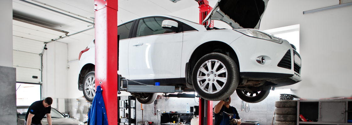 Car repair and maintenance theme. Mechanic in uniform working in auto service.